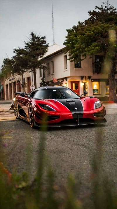 Red and Black Koenigsegg Luxury Sports Car on Street