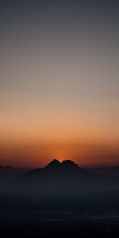 Summit Kiss - Sun Dipping Behind Mountain Peaks