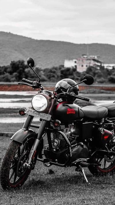 Royal Enfield Motorcycle with Helmet on Grassy Field