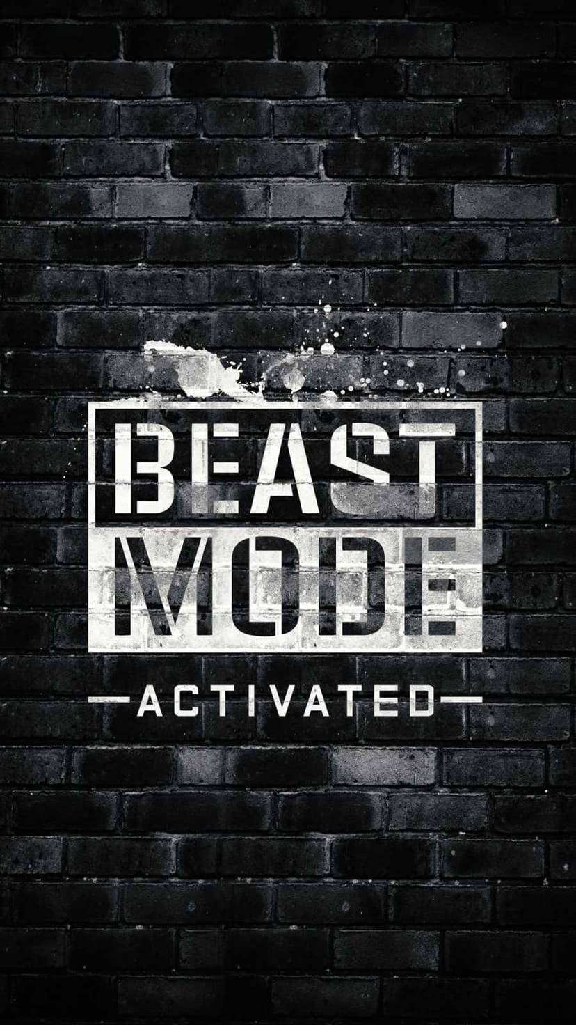 Beast Mode Activated white stencil text spray-painted on a dark textured brick wall in a vertical layout.