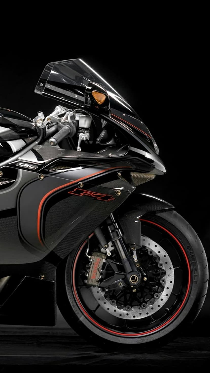 Black sportbike with a red-rimmed front wheel and exposed engine parts against a solid dark background.