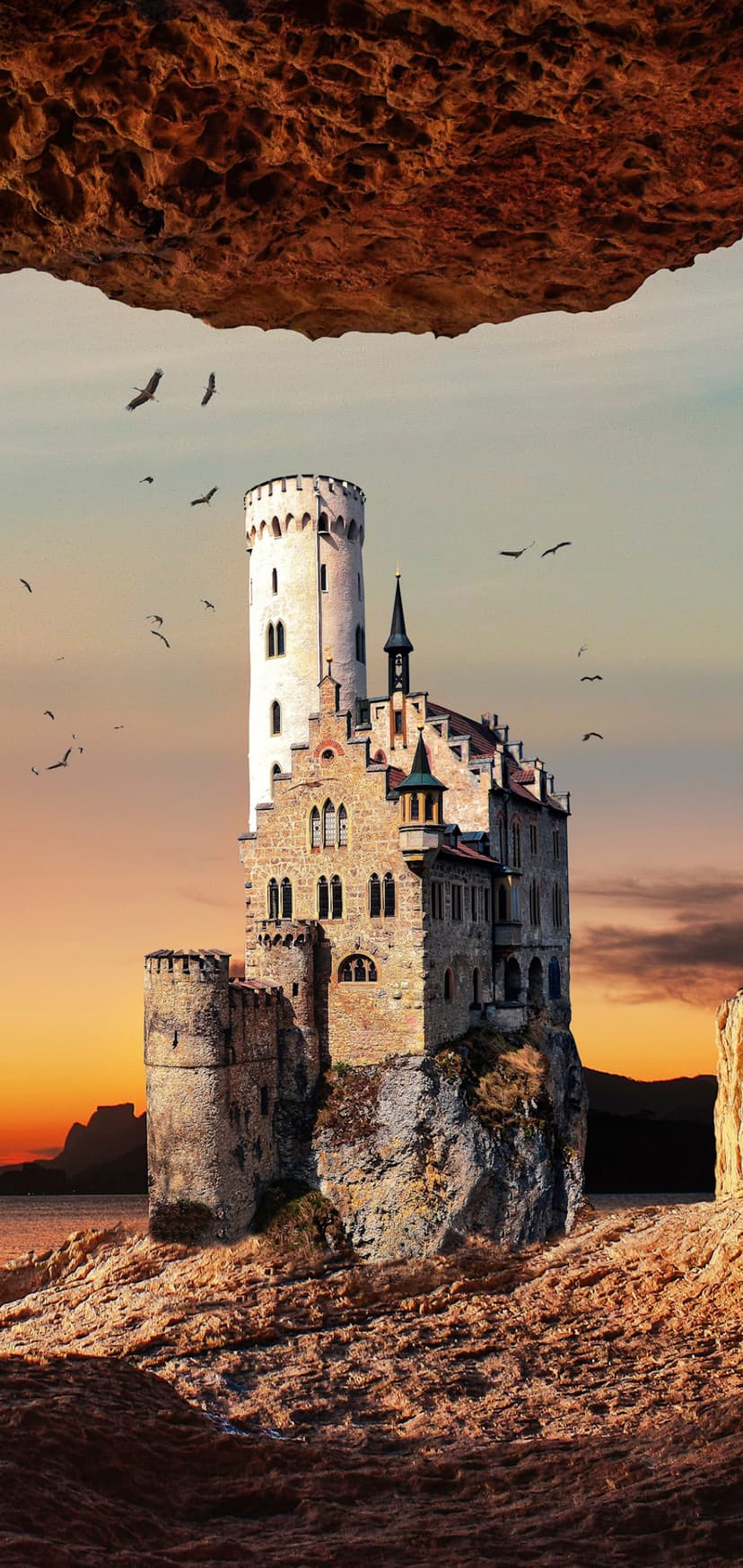 Medieval castle with stone turrets perched on a rugged cliff overlooking the ocean during a golden sunset.