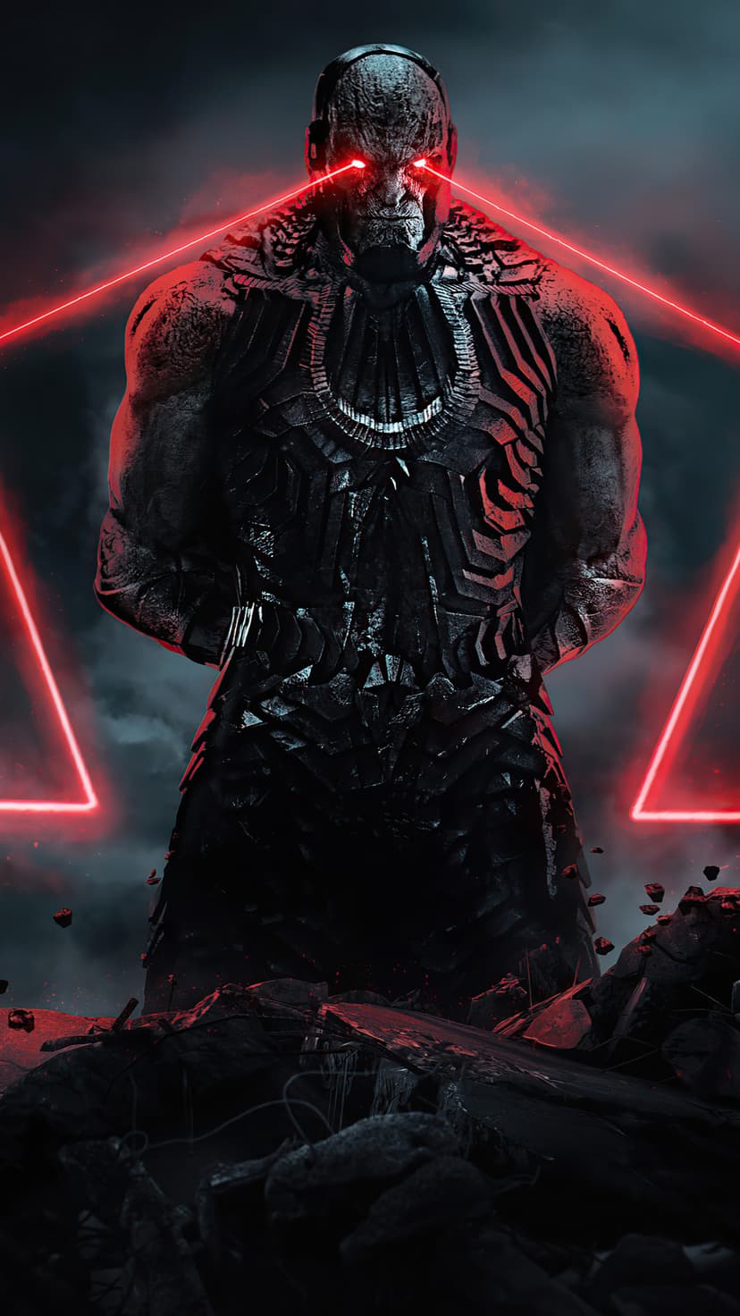 Darkseid fires glowing red energy beams from his eyes while wearing heavy metallic armor amidst gray rubble.