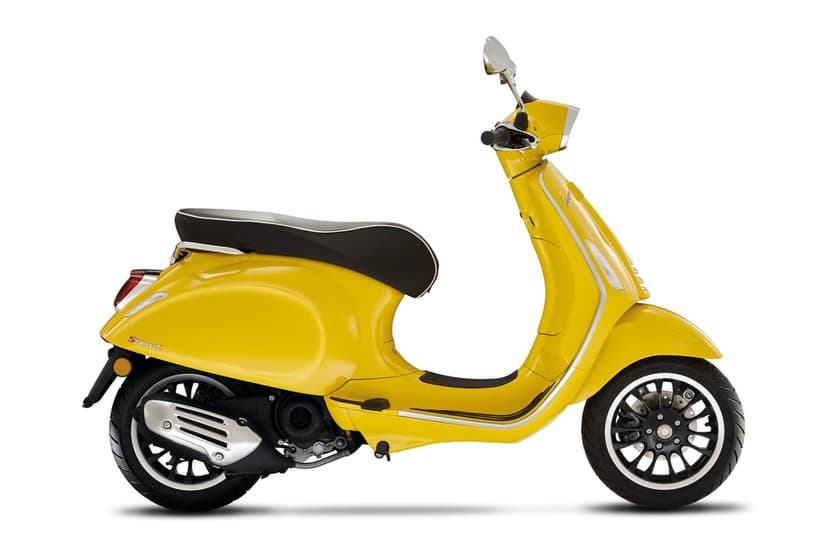 Side profile of a bright yellow Vespa Sprint scooter with chrome accents against a white background.