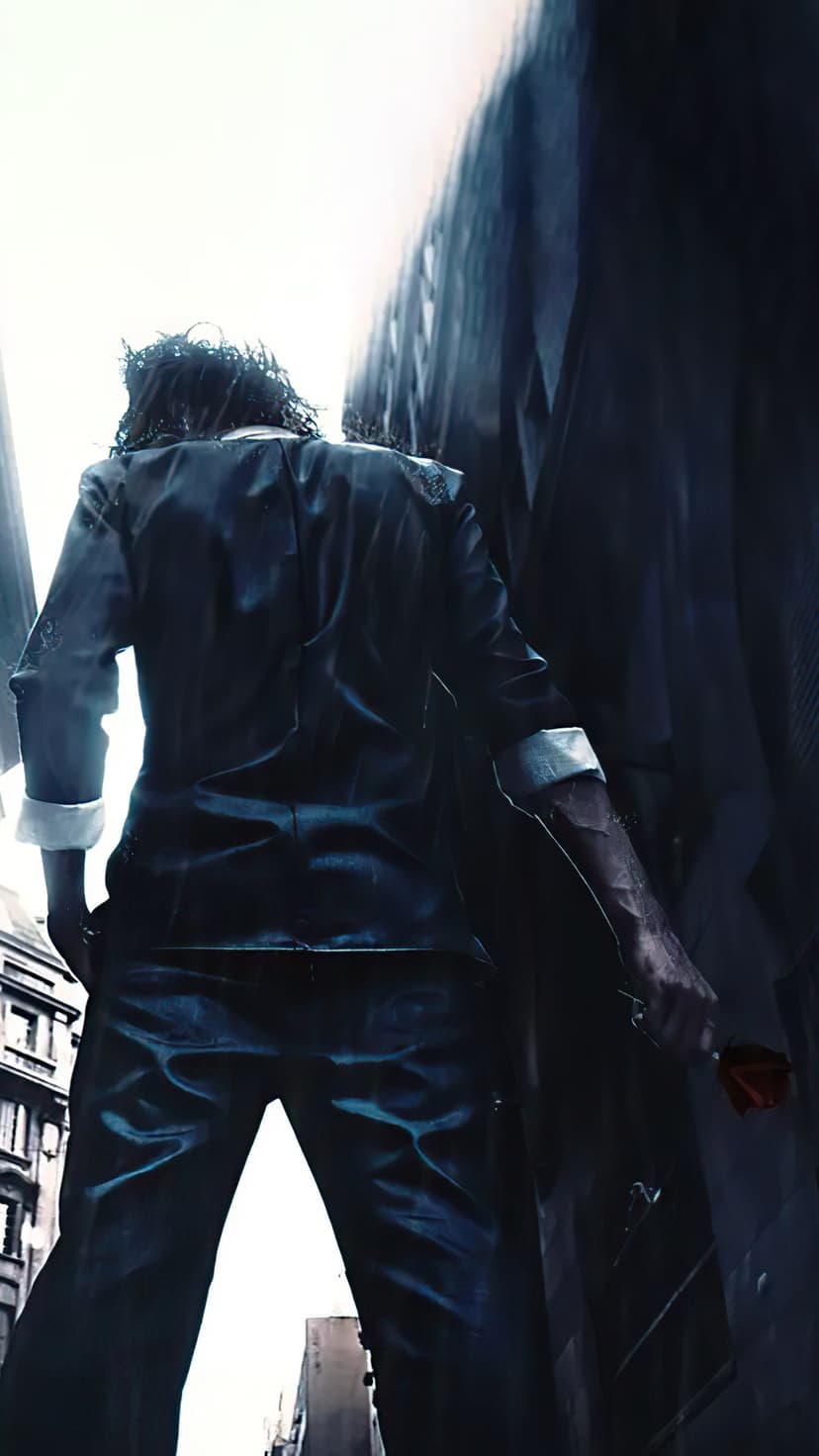 The Joker stands in a rainy dark alley holding a single red rose while facing away from the camera in Gotham.