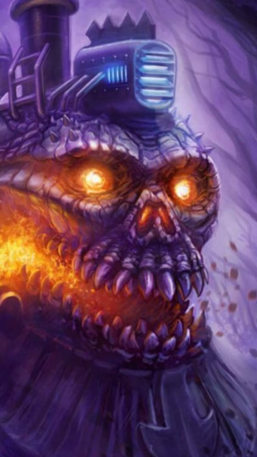 Skull-shaped train engine with glowing orange eyes and sharp teeth emitting orange flames in a dark purple forest.