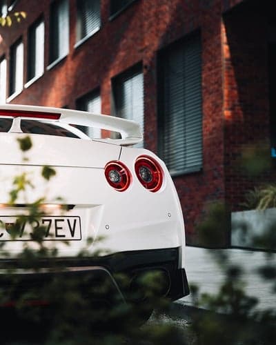 White Nissan GT-R Rear View with Brick Building