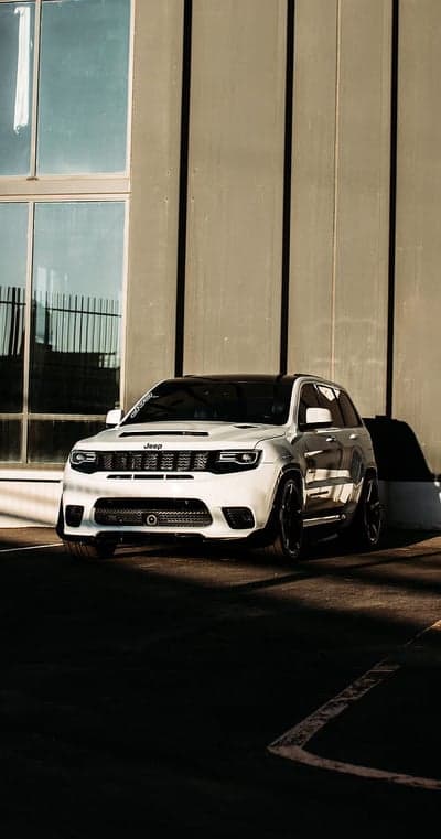 White Jeep Grand Cherokee SRT parked outside modern building