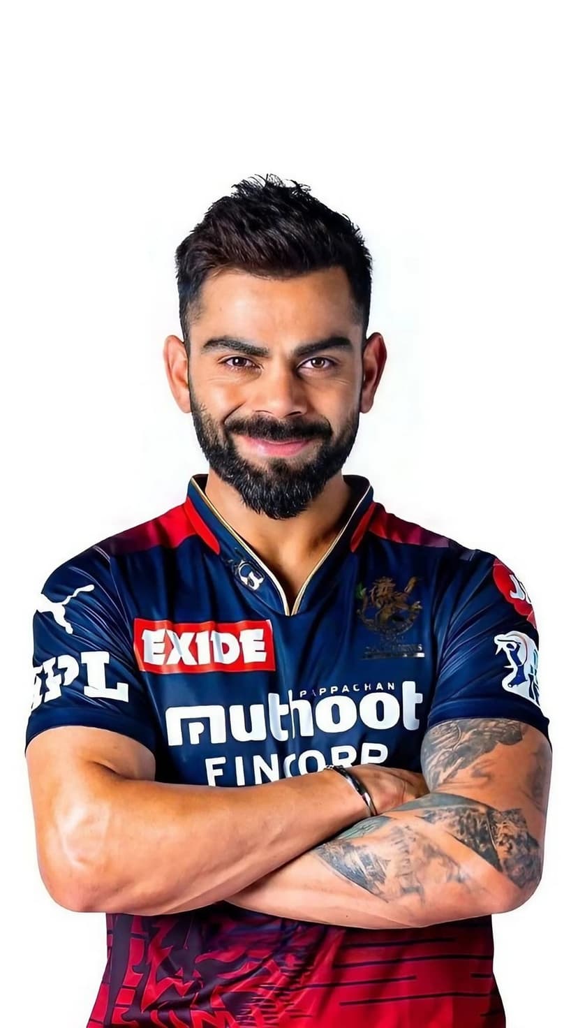 Virat Kohli smiles with arms crossed while wearing his red and black Royal Challengers Bangalore team jersey.
