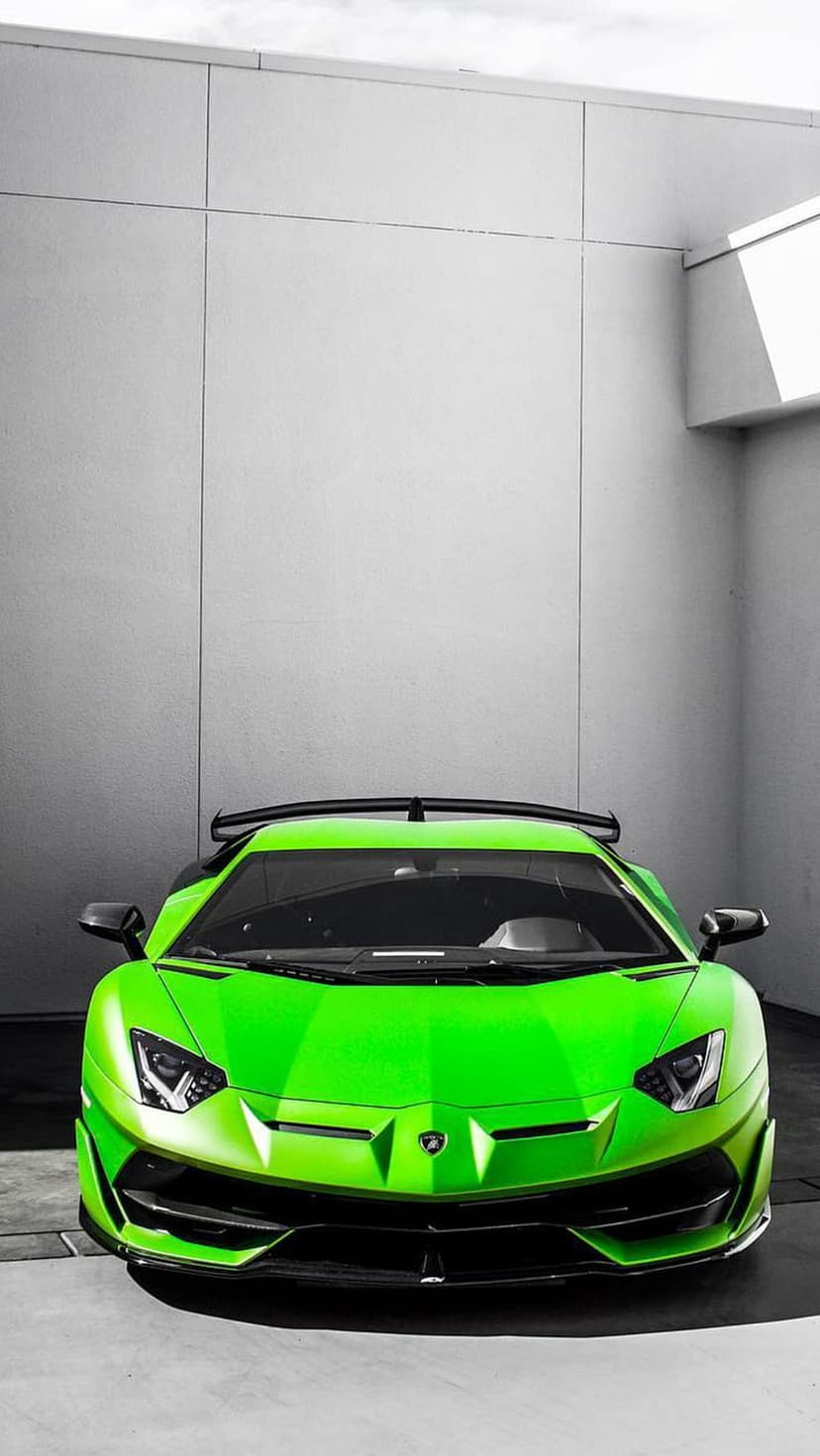 Lamborghini Aventador SVJ in lime green features sharp front vents and a rear wing within a minimalist interior.