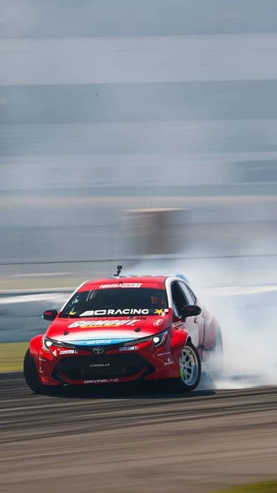 Drifting Toyota Corolla Kicks Up Smoke on Track