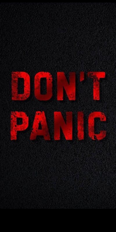 Don't Panic red grunge text on black textured background