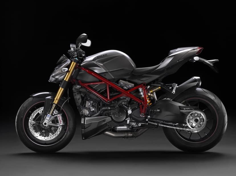Ducati Streetfighter S motorcycle with matte grey body and red trellis frame against a dark background.