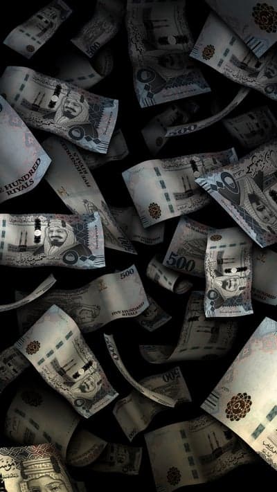 Falling Saudi Riyal Banknotes on Black Background