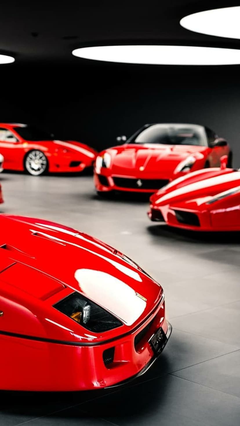 Ferrari F40 in red leading a row of luxury sports cars inside a dark, minimalist showroom with glossy reflections.