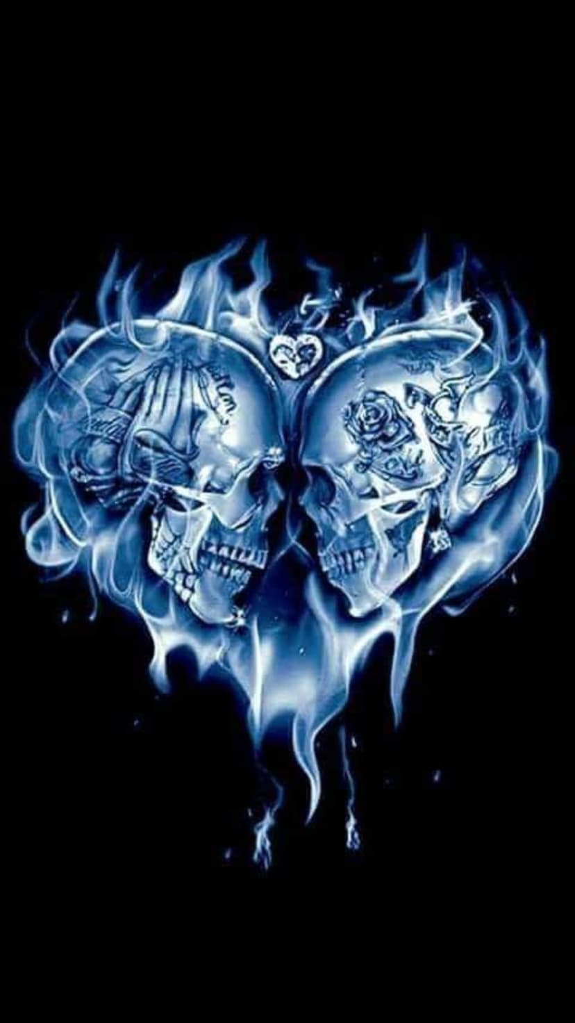 Twin skulls engraved with roses form a heart shape while engulfed in luminous blue flames against a black backdrop.