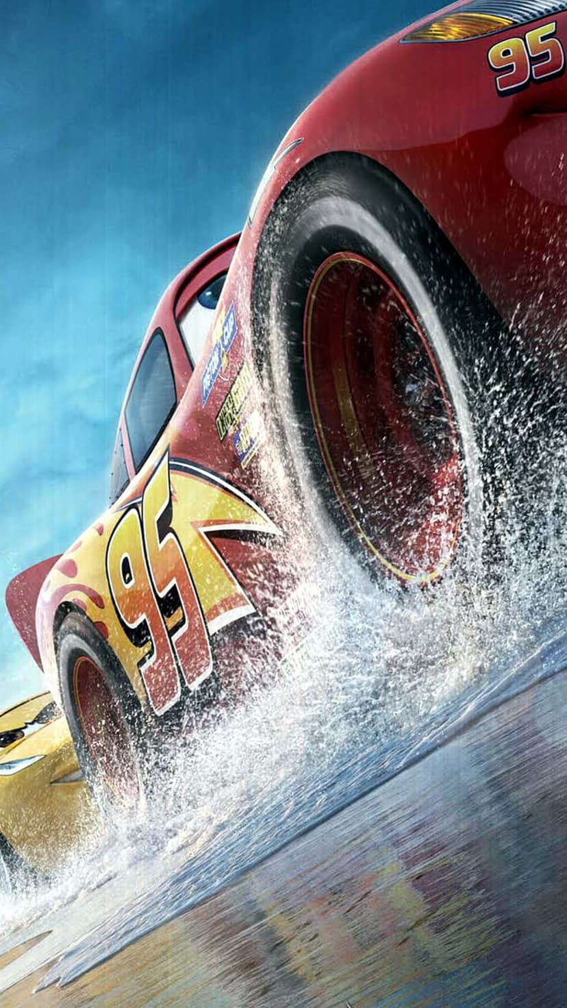 Lightning McQueen sprays water from his racing tires on a wet track under a bright blue sky during a race.