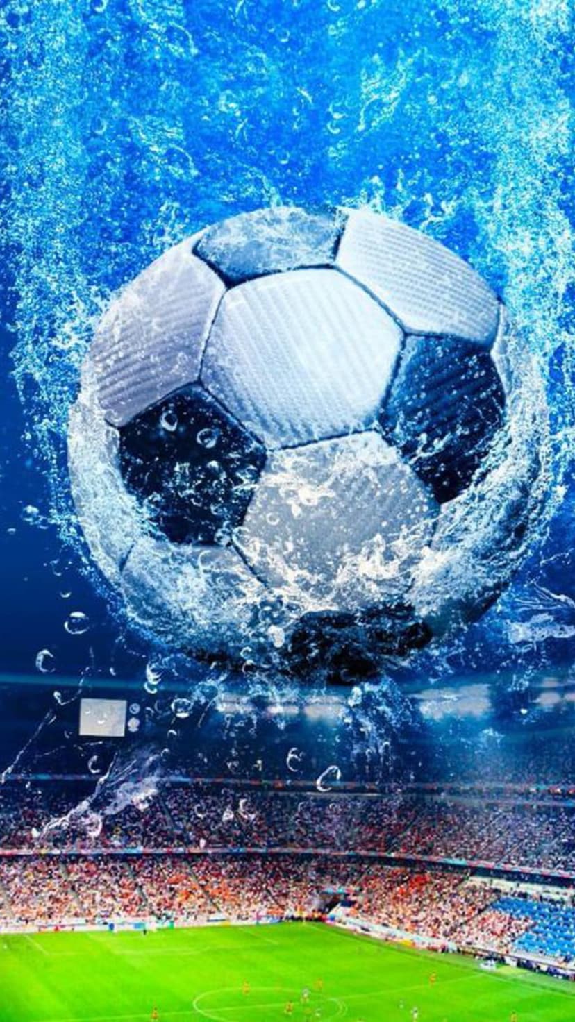Soccer ball submerged in splashing blue water with air bubbles against a blurred stadium crowd background.