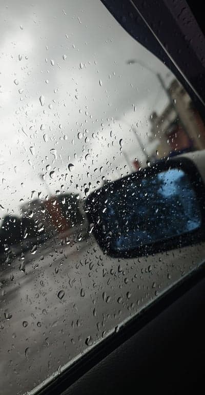 Rainy Urban Street View Car Window Mobile Wallpaper