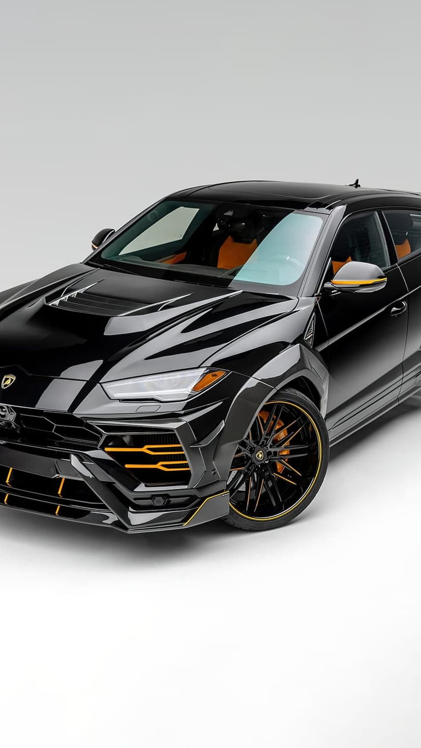 Lamborghini Urus in matte black with orange pinstriping on the wheels and body kit in a portrait view.
