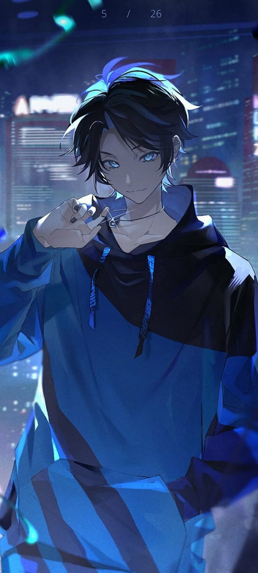 Young man with bright blue eyes and dark hair wearing a blue hoodie and necklace against blurred city lights.