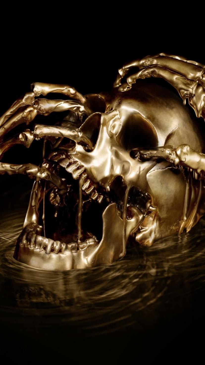 Golden skull melting into black liquid with skeletal hands emerging from dark ripples under dramatic lighting.
