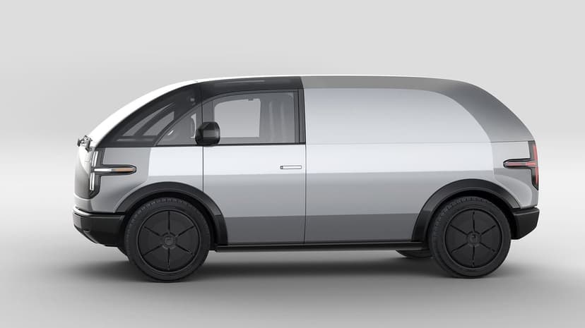 Silver futuristic electric van side profile with large glass cockpit and black wheels on a gray background.