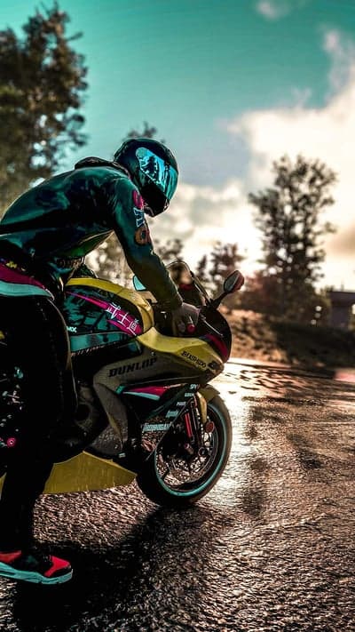 Motorcyclist in Stylish Gear on a Wet Road