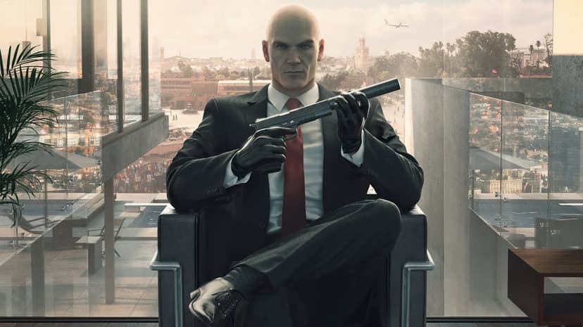 Agent 47 in a black suit sits in a chair holding a suppressed pistol against a sunny city background.