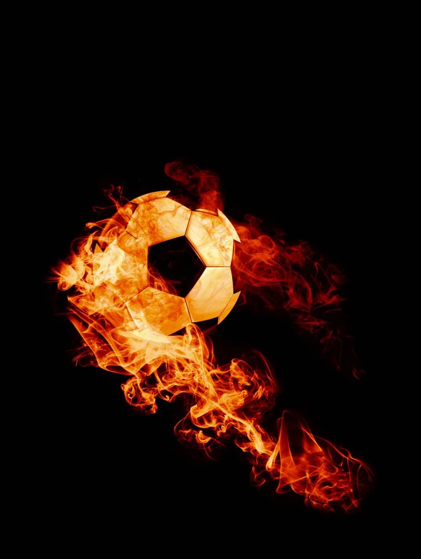 Soccer ball engulfed in orange and red flames with grey smoke trails against a solid black background.