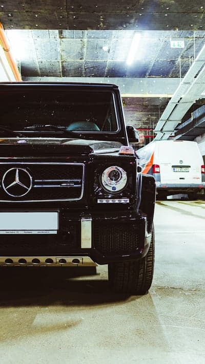 Black Mercedes G-Wagon parked in a dimly lit garage