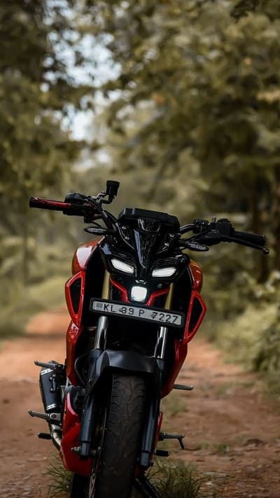 Red Yamaha MT-15 Motorcycle on a Forest Road