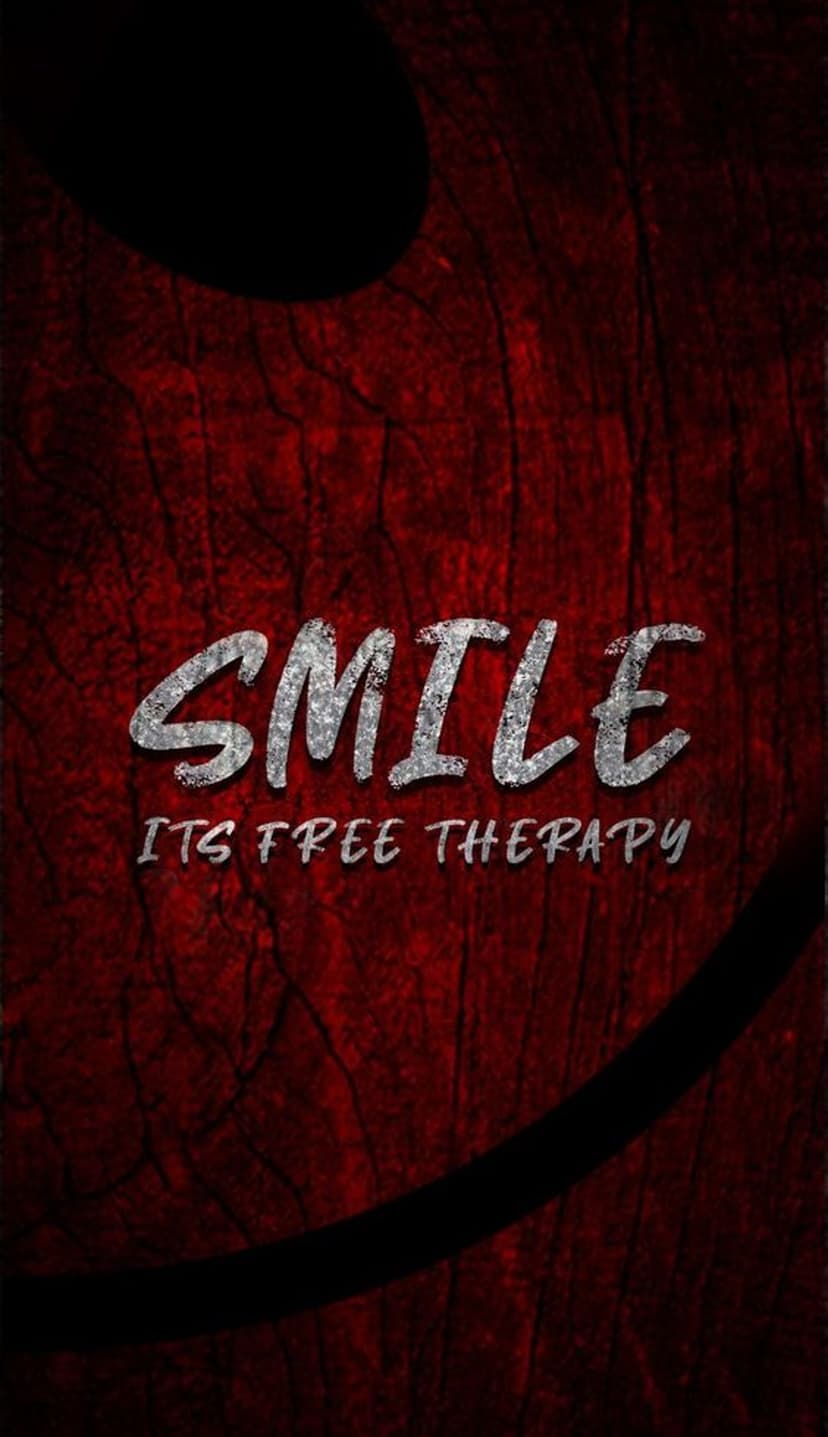 Silver metallic lettering spelling Smile It's Free Therapy over a dark red wood texture with a faint smile.