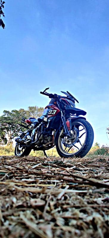 Motorcycle parked in natural setting with blue sky