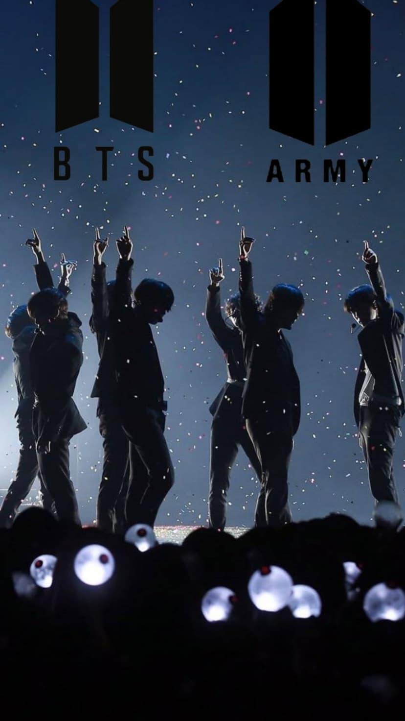 BTS members silhouetted on a blue stage with falling confetti, a glowing logo, and audience lightsticks.