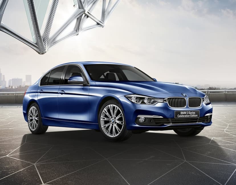 Blue BMW 3 Series sedan parked on a geometric rooftop with a metallic lattice structure and city skyline.
