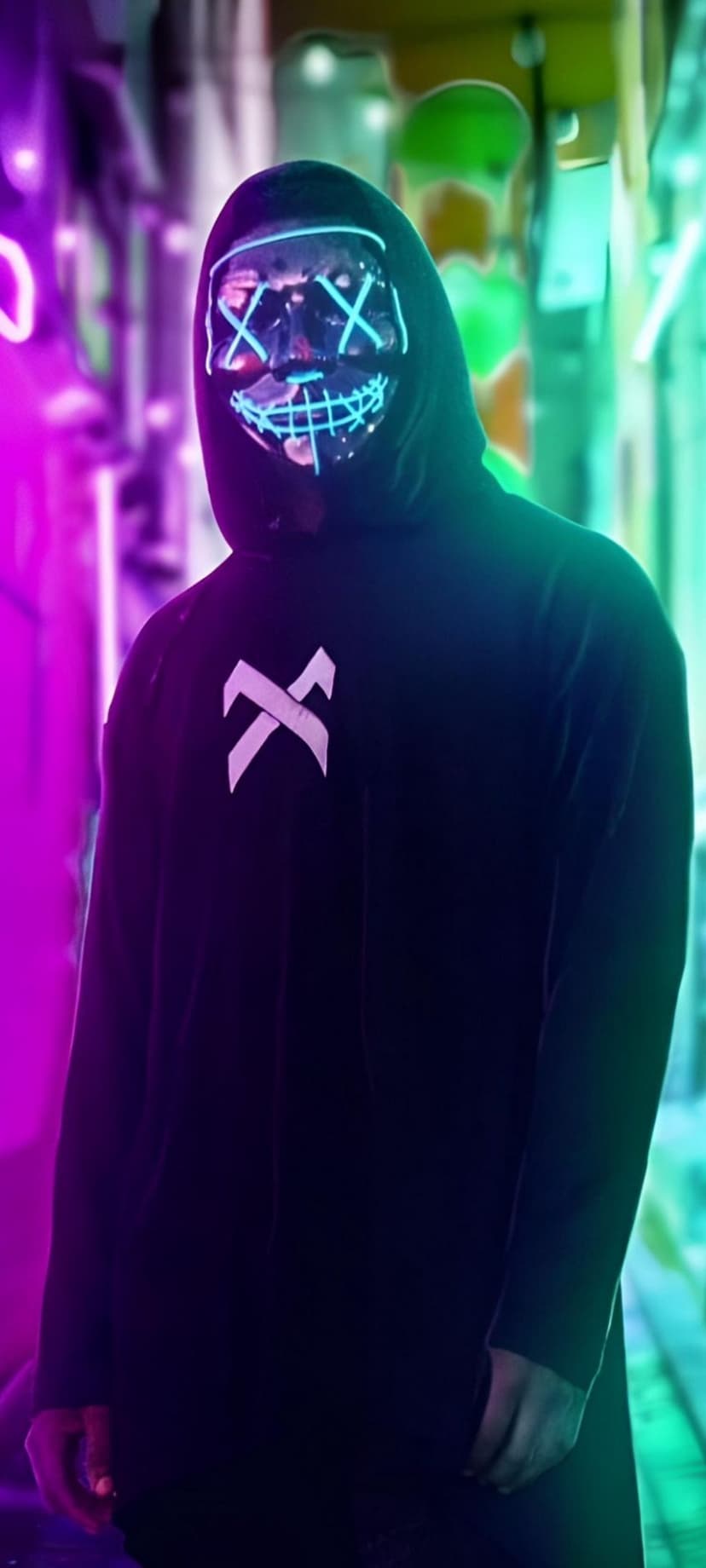 Person in a black hoodie wearing a glowing blue LED mask stands in a pink and green neon-lit urban alleyway.