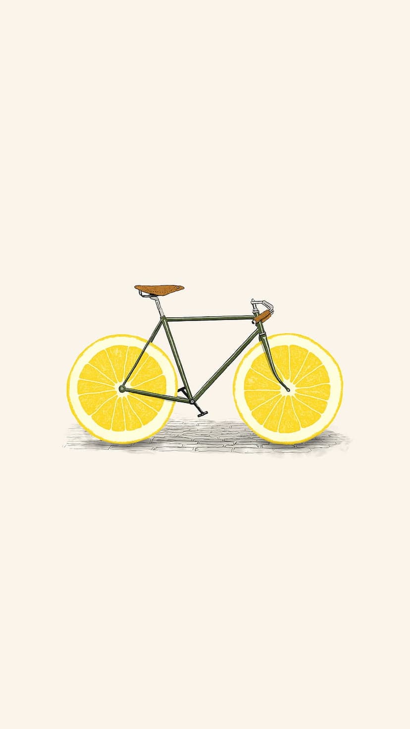 Vintage bicycle with vibrant yellow lemon slices for wheels parked against a minimalist cream background.