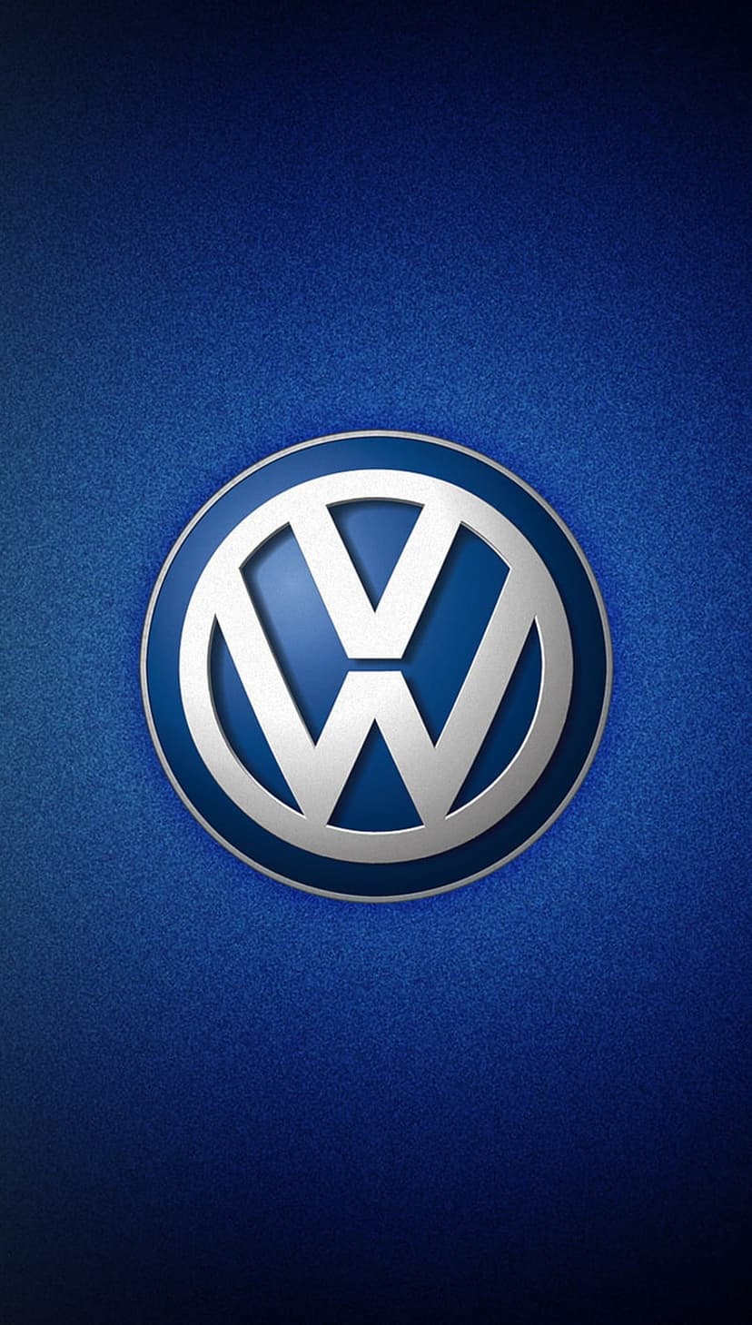 Silver Volkswagen circular emblem centered on a textured metallic blue background with subtle radial gradients.