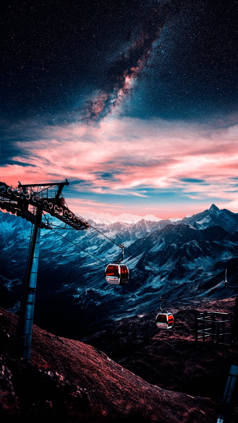 Milky Way galaxy glows above two gondola cabins and jagged mountain peaks under a pink and blue twilight sky.