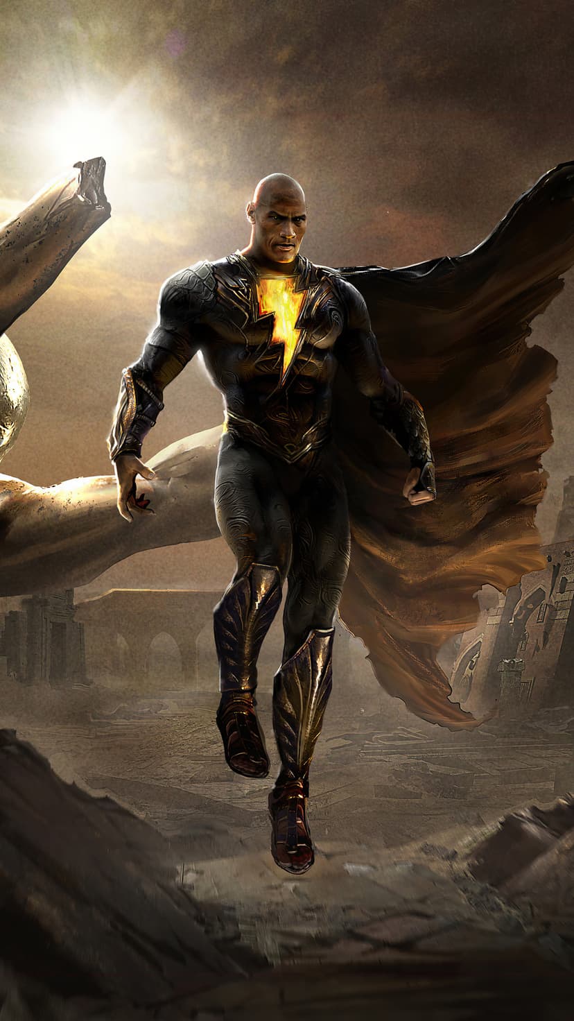Black Adam floats in a desert wearing a black and gold suit with a glowing yellow lightning bolt on his chest.