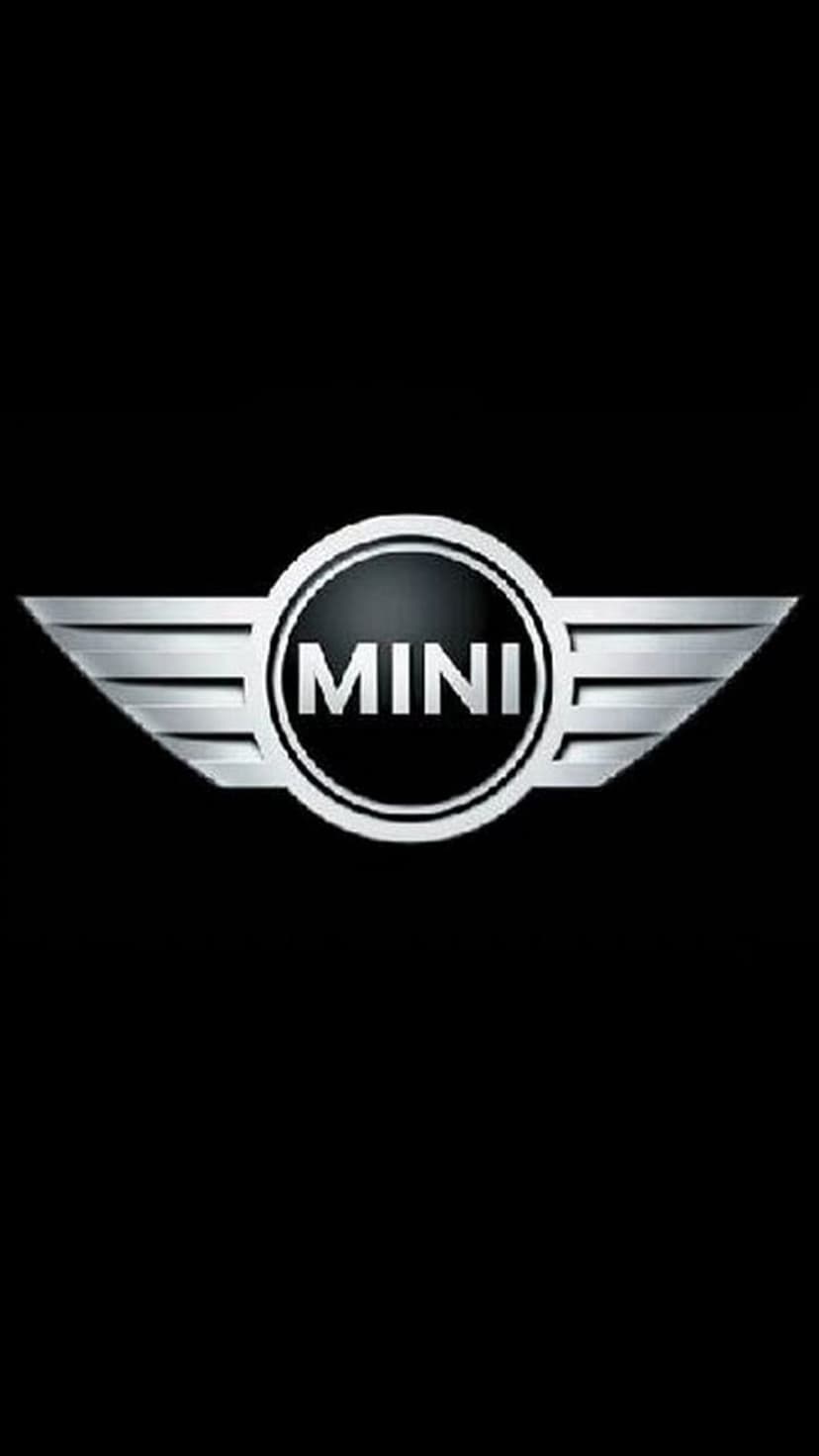 Silver MINI Cooper winged emblem centered on a solid black background with metallic textures and chrome finish.