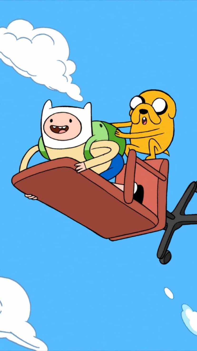 Finn and Jake sit on a black office chair floating amidst white fluffy clouds under a bright blue summer sky.