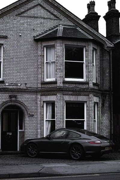 Porsche 911 Parked by Traditional Brick House Wallpaper