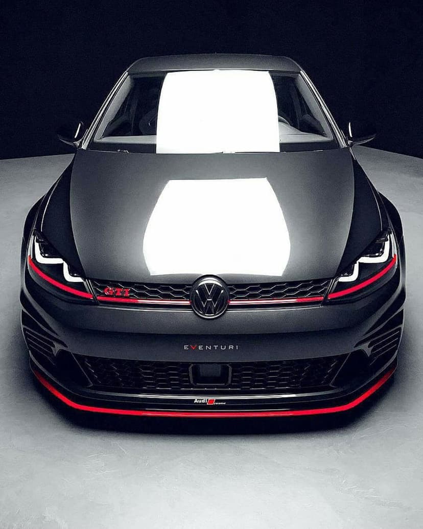 VW Golf GTI front view in dark gray paint with red trim and Eventuri logo under focused studio lighting.