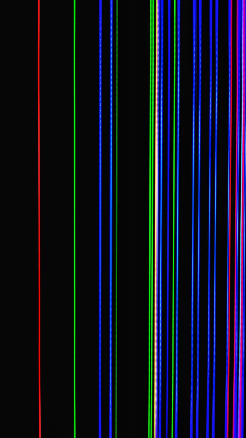 Bright red, green, and blue vertical lines contrast against a solid black background in a sharp linear pattern.