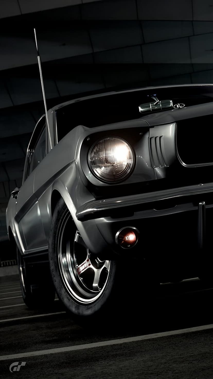 Silver Ford Mustang GT front profile featuring a glowing round headlight, chrome trim, and dark background.
