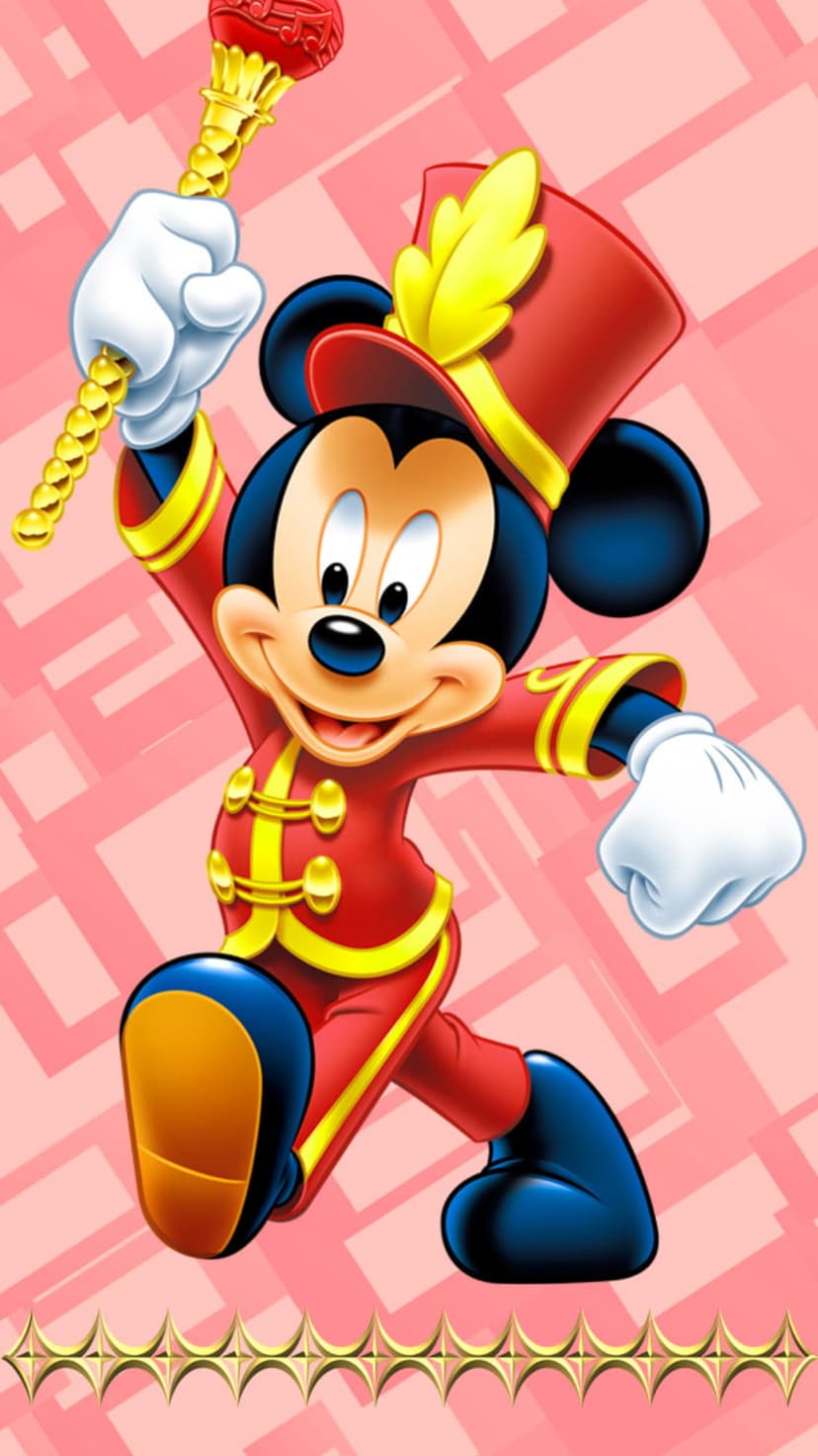 Mickey Mouse in a red and gold band uniform holds a golden baton against a soft pink geometric backdrop.