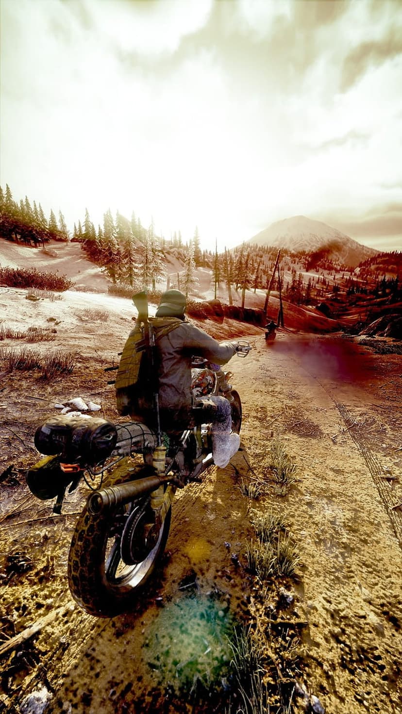 Biker in heavy survival gear riding a motorcycle through deep snow with sunlit mountain peaks in the distance.