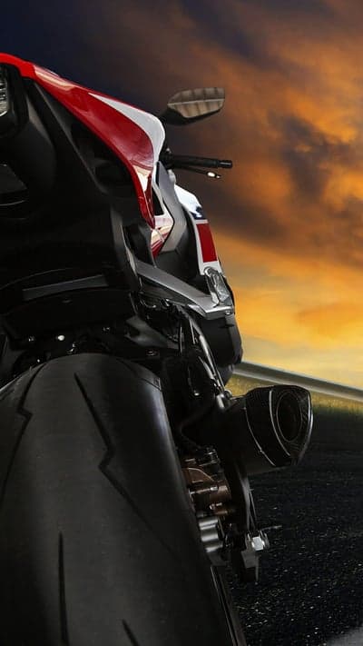 Motorcycle Tail End at Dramatic Sunset on Road